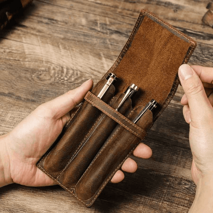 3-slot leather pen case closed with a secure strap closure