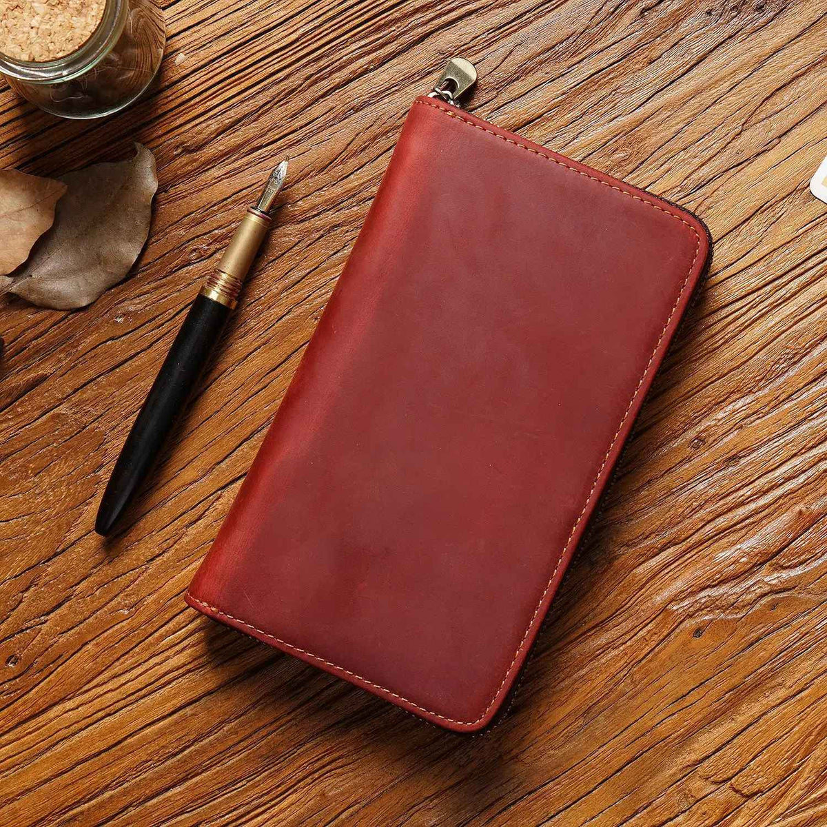 Compact leather pen case displayed closed with its zipper