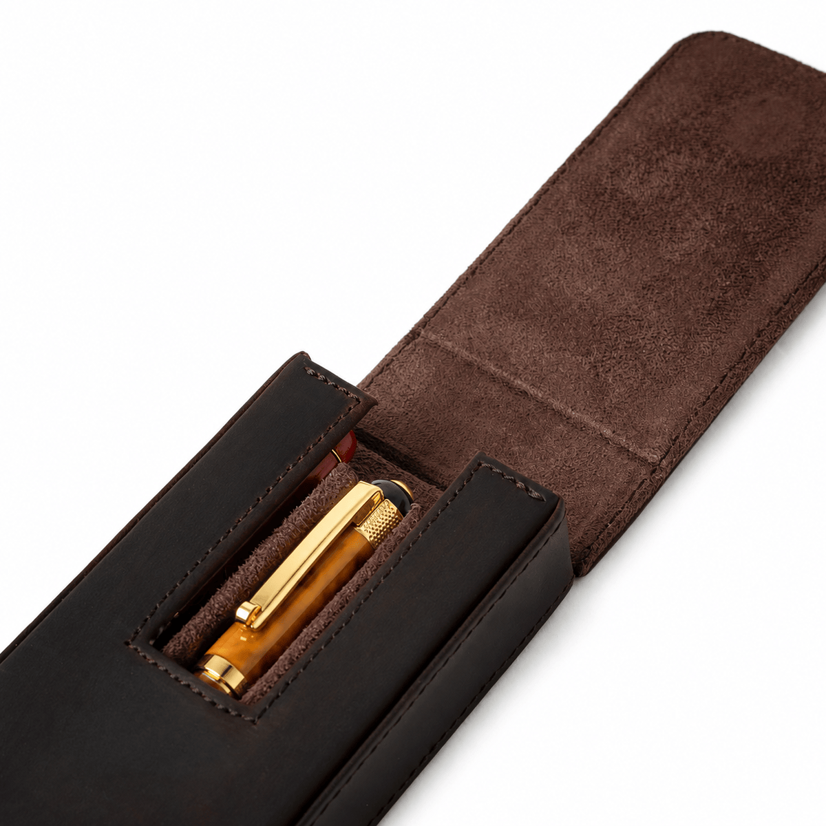 Open leather case holding three pens