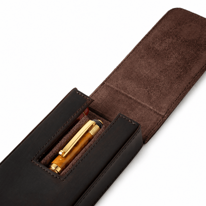 Open leather case holding three pens