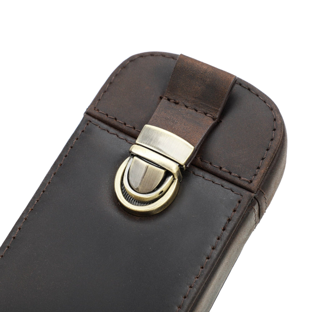 Close-up of the brass closure on a leather pen case
