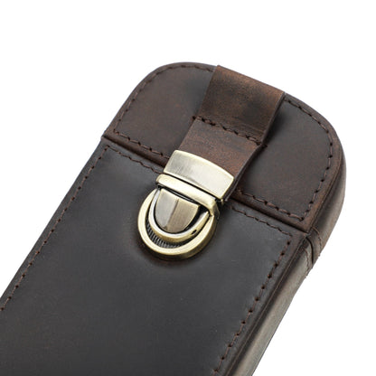 Close-up of the brass closure on a leather pen case