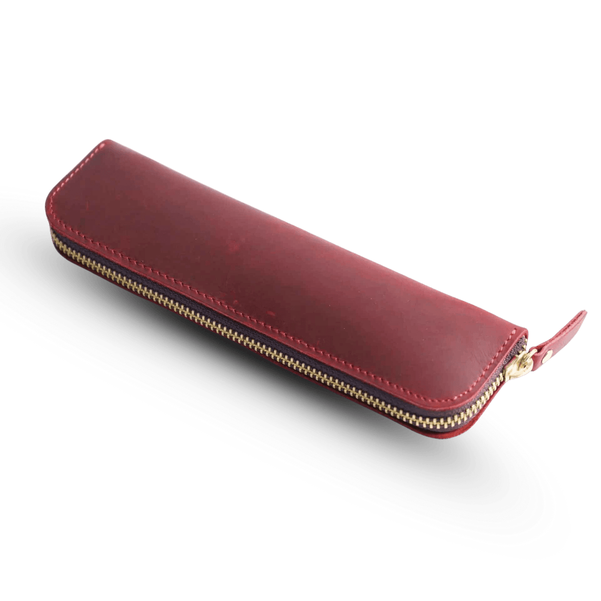 Leather zippered pen case shown with writing instruments