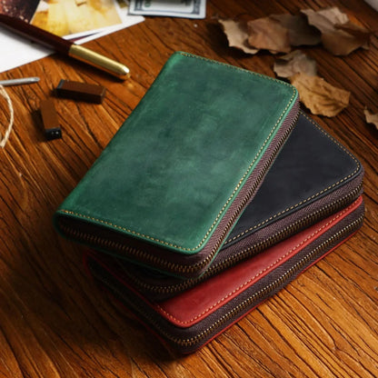 Open leather pen case showing five organized pen slots