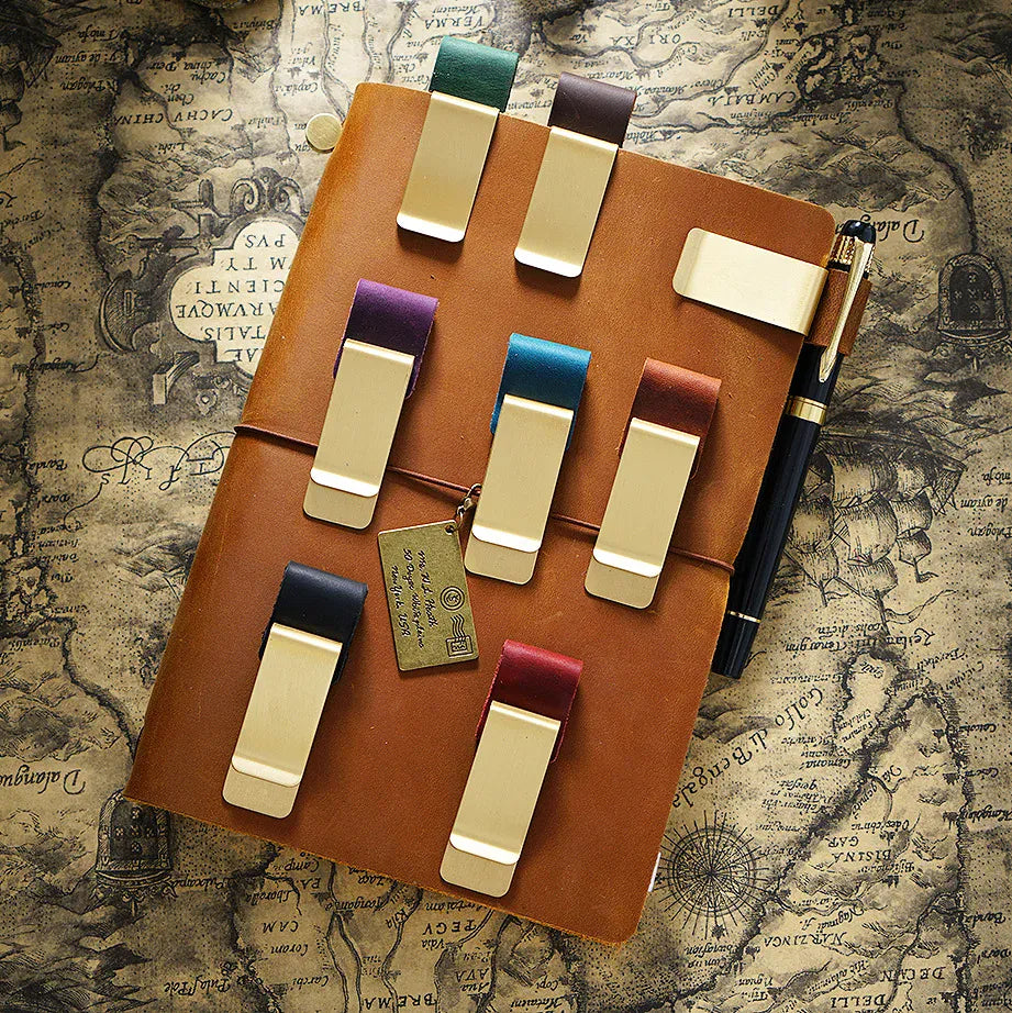 Journal accessory holding a pen securely beside a notebook cover