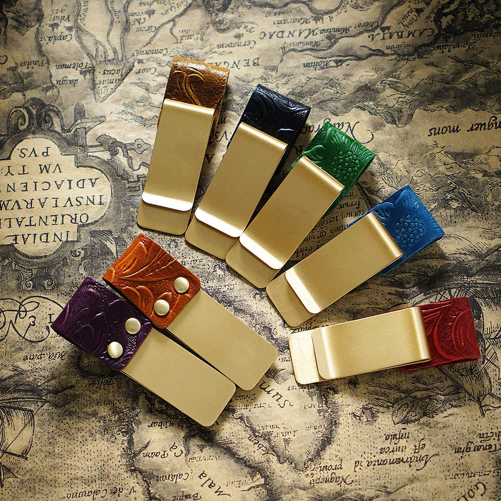 Leather band wrapping around a journal with a pen and cards in place