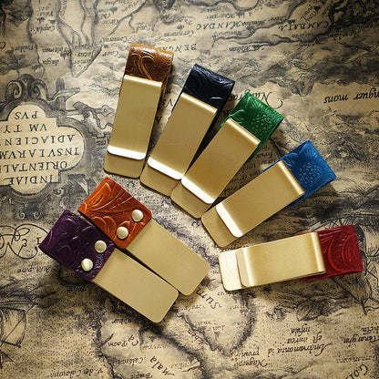 Leather band wrapping around a journal with a pen and cards in place