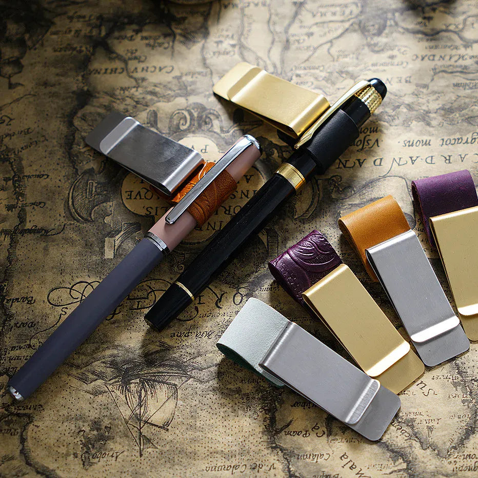 Leather journal pen clip with card and cash holder attached to a notebook