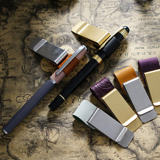 Leather journal pen clip with card and cash holder attached to a notebook