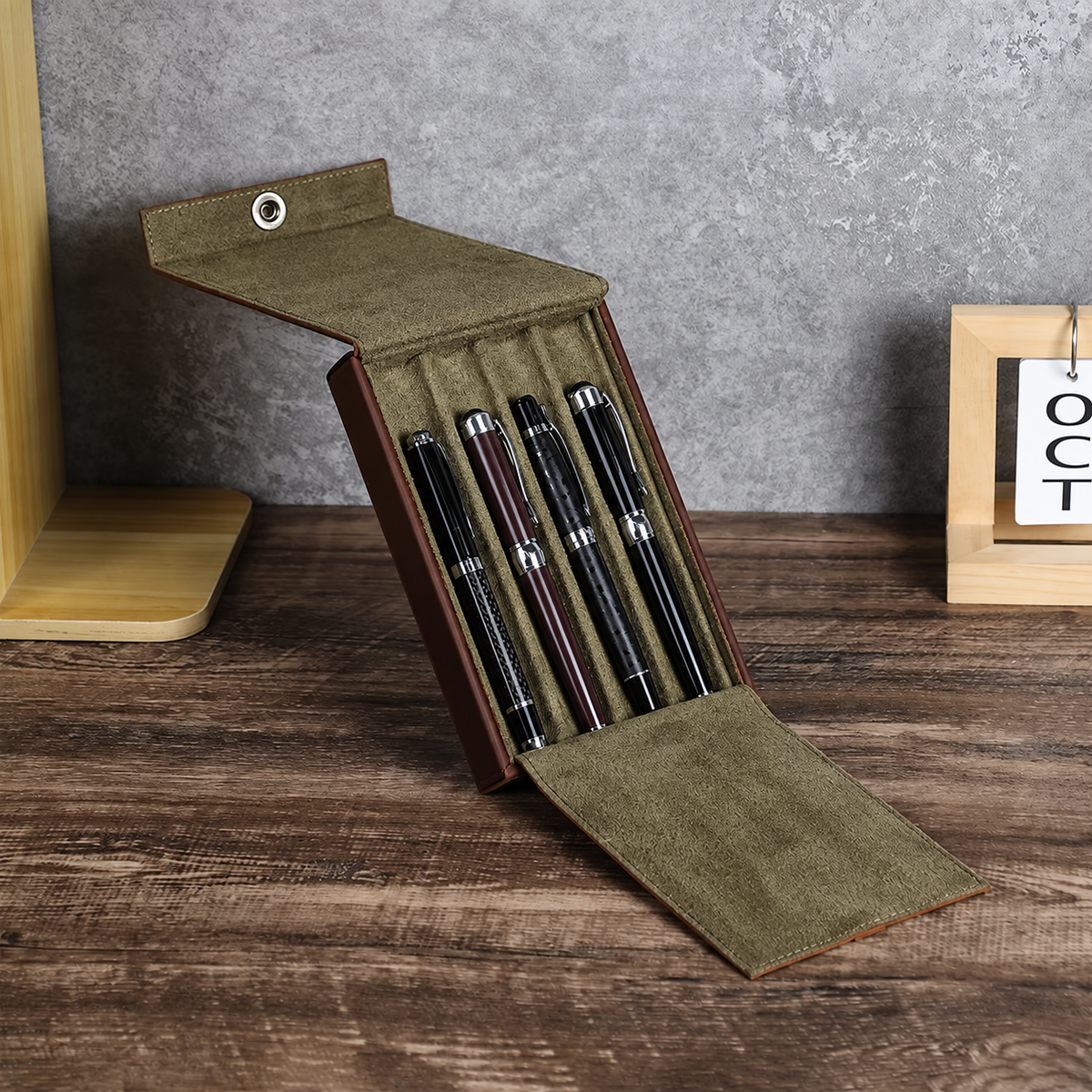 Open leather 4-pen case showing individual pen storage compartments