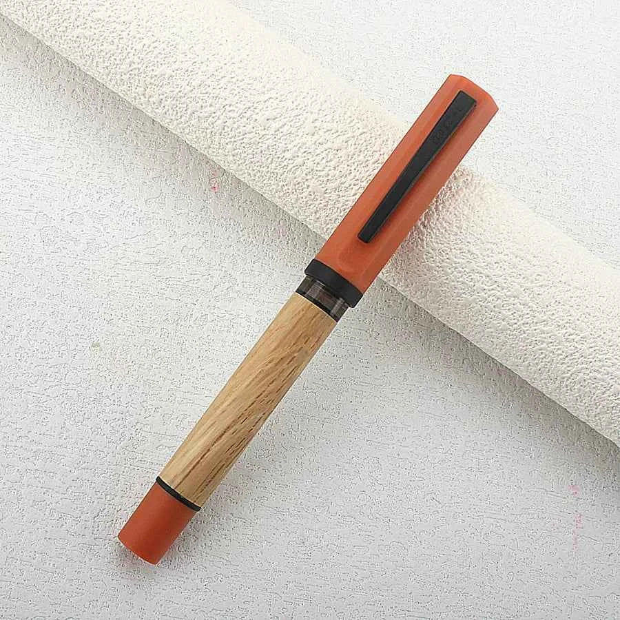 Elegant wooden fountain pen ready for writing on a blank page