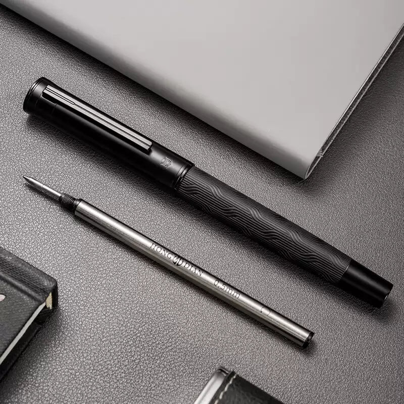 Rollerball pen displayed beside two included replacement refills