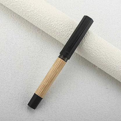 Wooden fountain pen cap removed to show the writing nib