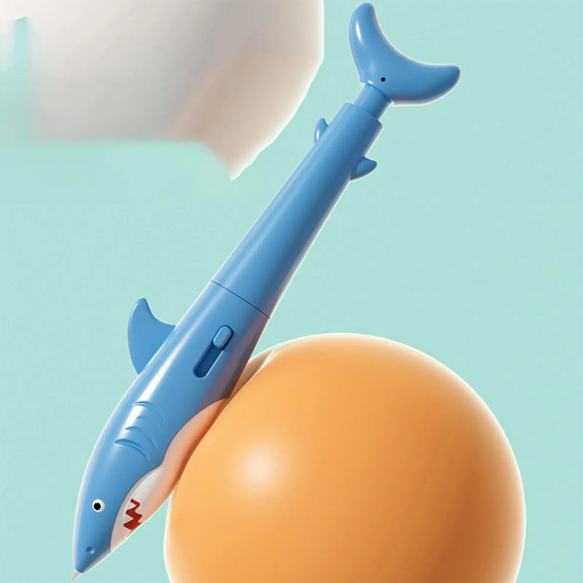Shark water squirter pen prank toy held in one hand