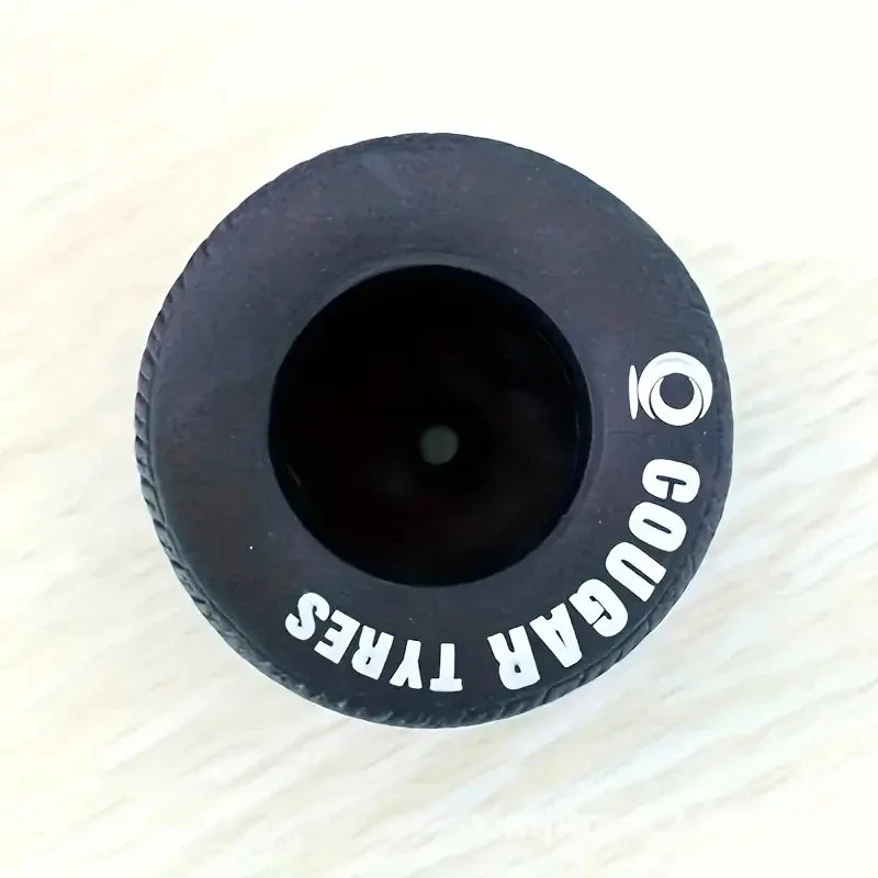 Decorative tire pen container beside a notebook on a desk