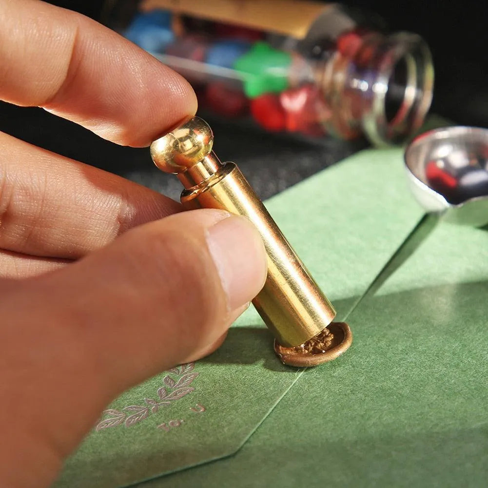 Seal stamp positioned beside envelopes and stationery