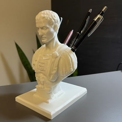 Sculptural bust-shaped pen holder displayed as a desk organizer